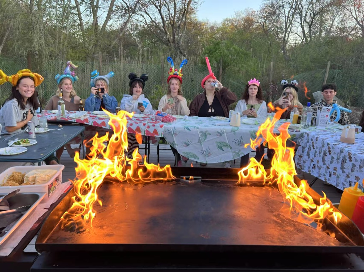 Hibachi chef performing fire show at Boston backyard party