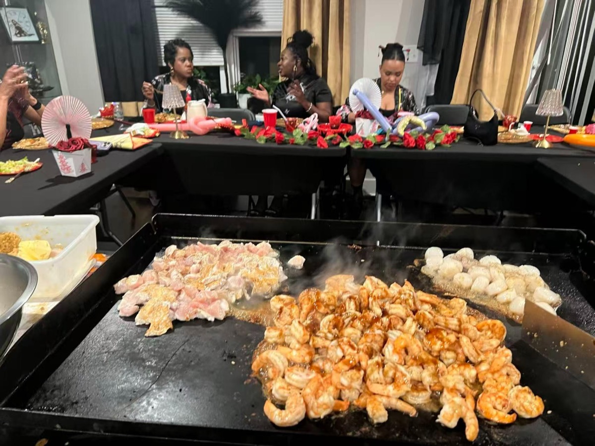 Hibachi chef cooking steak and shrimp