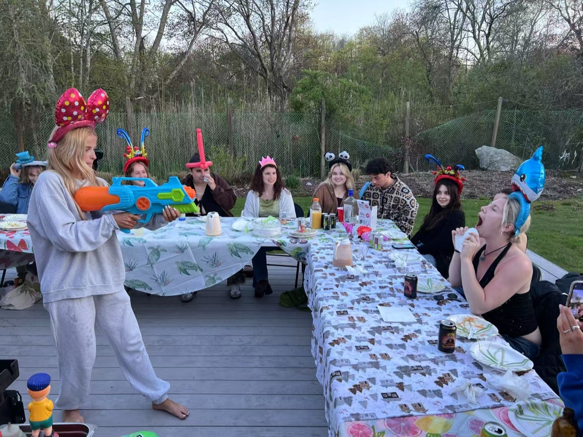 Friends enjoying outdoor hibachi party in Boston backyard